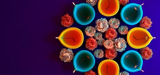 Image of several blue and orange fig-shaped butter lamps arranged with flowers around them and in the middle.