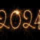 a black background with a sparkler painting the numbers 2024 in the sky