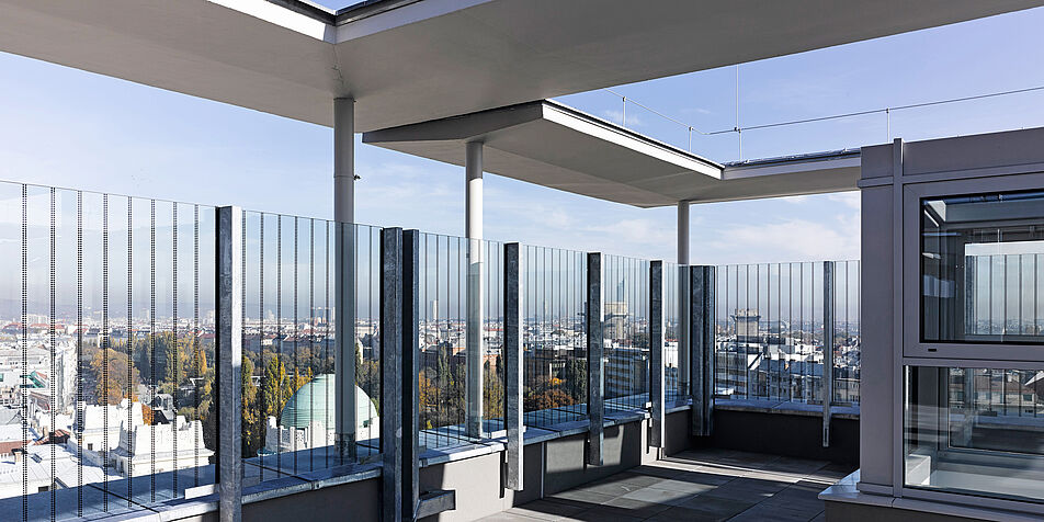 Photo of roof terrace with view of city