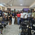 Photo of many attendees at MautiCamp Africa standing at the front of a classroom.