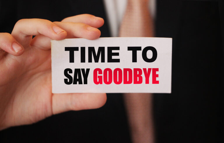 Time to Say Goodbye words on a card in hand of businessman.