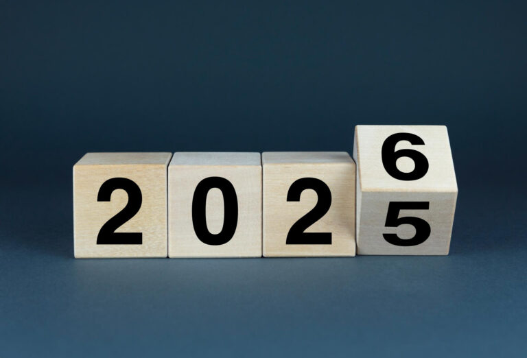 A photo of four cubes showing the numbers 2 0 2 5, with the 5 rolling over to show 6.