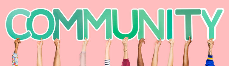 Image of people holding up the letters spelling out community.