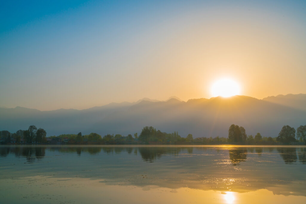 Sunrise over a misty lake Dal in Kashmir, India.